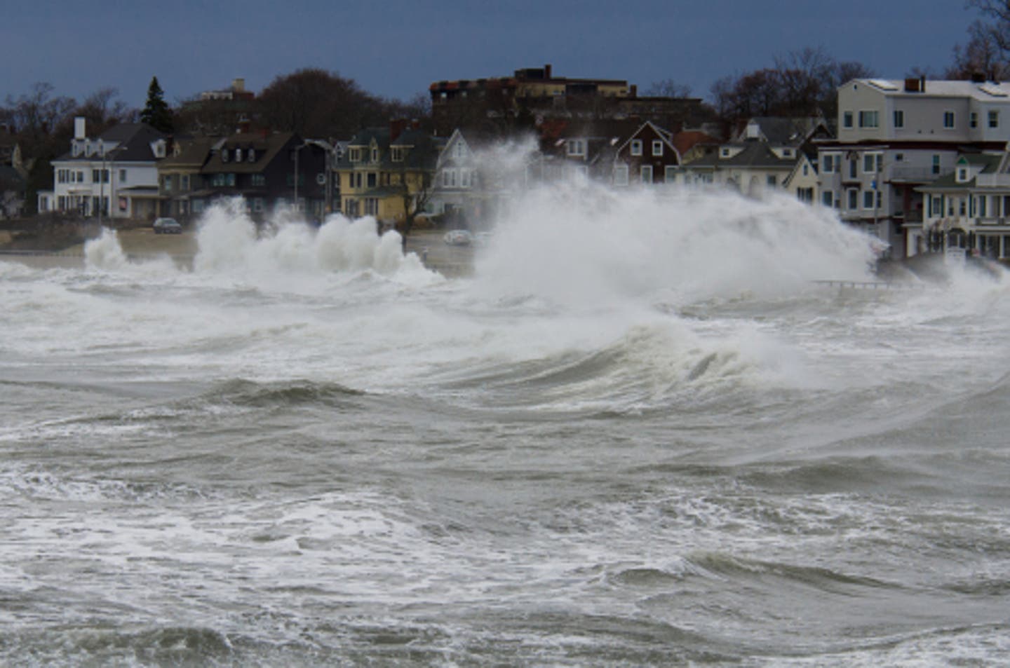 Coastal flood watch showing rising water near homes along a shoreline